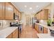 Bright kitchen with stainless steel appliances, wood cabinets, and hardwood flooring at 2545 Nashira St, Henderson, NV 89044