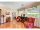 Bright living room featuring hardwood floors, decorative seating, and sunlit windows with neighborhood views at 2545 Nashira St, Henderson, NV 89044