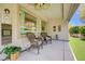 Inviting covered patio with comfortable rocking chairs, clock and decor at 2545 Nashira St, Henderson, NV 89044