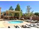 Community pool area featuring a small spa with an overhead trellis and ample lounge seating for residents to enjoy at 2545 Nashira St, Henderson, NV 89044