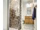 Modern bathroom featuring tiled shower, vanity with mirror, and neutral color scheme at 27 Sirnoble St, Las Vegas, NV 89110