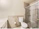 Clean bathroom with tile flooring, toilet, and enclosed glass shower at 27 Sirnoble St, Las Vegas, NV 89110