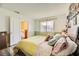 Sunlit bedroom features soft yellow bedding and whimsical decor, creating a peaceful and inviting retreat at 27 Sirnoble St, Las Vegas, NV 89110
