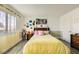 Cozy bedroom with natural light, featuring warm yellow bedding and colorful decor, creating a comfortable and inviting atmosphere at 27 Sirnoble St, Las Vegas, NV 89110