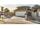 Charming two-story home with a two car garage and gated entry provides privacy and curb appeal at 27 Sirnoble St, Las Vegas, NV 89110