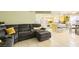 Open concept living space with gray sectional, tile flooring, connecting to the kitchen at 27 Sirnoble St, Las Vegas, NV 89110