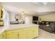 The kitchen breakfast bar overlooks the cozy living room with a fireplace and tv at 27 Sirnoble St, Las Vegas, NV 89110