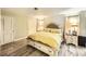 Bright bedroom with wood-look flooring, neutral walls, and a queen-sized bed at 27 Sirnoble St, Las Vegas, NV 89110