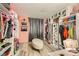A large walk-in closet features an ottoman, dressing area, and ample storage, creating an organized and stylish space at 27 Sirnoble St, Las Vegas, NV 89110
