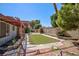 Private backyard oasis featuring a pergola, artificial turf, and mature landscaping at 2700 Osborne Ln, Henderson, NV 89014