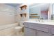 Bathroom with shower, toilet, sink, and blue accents at 2700 Osborne Ln, Henderson, NV 89014