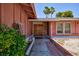 Inviting entryway featuring double doors, brick accents, and well-maintained landscaping at 2700 Osborne Ln, Henderson, NV 89014