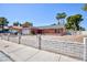 This single-story home showcases mature trees, a two-car garage, and a charming brick facade at 2700 Osborne Ln, Henderson, NV 89014