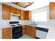 Kitchen featuring wood cabinets, white counters, gas range and updated appliances at 2700 Osborne Ln, Henderson, NV 89014