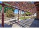 Covered patio featuring a pergola, outdoor seating, and a manicured lawn at 2700 Osborne Ln, Henderson, NV 89014