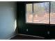 Dark and basic bedroom featuring a view of the unkempt exterior at 2700 W Prospector Ln, Pahrump, NV 89048
