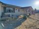 Single-story home with a cozy front porch and large front window providing plenty of natural light at 2700 W Prospector Ln, Pahrump, NV 89048