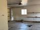 Dirty and empty garage with shelving along walls and a window at 2700 W Prospector Ln, Pahrump, NV 89048