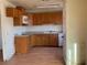 Modest kitchen features wood cabinets and a white appliance at 2700 W Prospector Ln, Pahrump, NV 89048