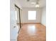 A bright bedroom with wood floors, a mirrored closet, and a ceiling fan at 2721 Coffee Pot Ct, Las Vegas, NV 89106