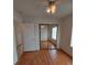 A bright bedroom featuring laminate flooring, a ceiling fan, and sliding mirror closet doors at 2721 Coffee Pot Ct, Las Vegas, NV 89106