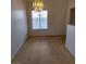 Dining area features tile floors, a modern chandelier, and natural light at 2721 Coffee Pot Ct, Las Vegas, NV 89106