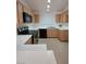 Functional kitchen with oak cabinets, black appliances, and white countertops at 2721 Coffee Pot Ct, Las Vegas, NV 89106