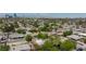 Wide neighborhood aerial showcasing residences with mature trees and desert landscaping with the city skyline at 2825 Burnham Ave, Las Vegas, NV 89169
