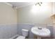 Cozy half-bathroom featuring tiled walls at 2825 Burnham Ave, Las Vegas, NV 89169