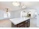 Kitchen island with dark wood cabinets, tile countertops, and vintage pendant lighting at 2825 Burnham Ave, Las Vegas, NV 89169