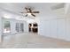Open living area with tile floors, ceiling fan, closet and kitchen view at 2825 Burnham Ave, Las Vegas, NV 89169