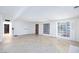 Bright living room featuring tile floors, large windows with shutters, and white walls at 2825 Burnham Ave, Las Vegas, NV 89169