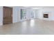 Spacious living room with tile floors, large windows, shutters, and an ornate fireplace at 2825 Burnham Ave, Las Vegas, NV 89169