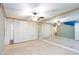 Primary bedroom featuring tile floors, ceiling fan, and a mirror wall at 2825 Burnham Ave, Las Vegas, NV 89169