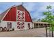 Exterior of Sierra Vista Ranchos barn featuring a red and white painted facade at 3189 Montecito Dr, Las Vegas, NV 89120