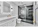 Contemporary bathroom with sleek glass shower, black tile accent wall, and modern white vanity at 3189 Montecito Dr, Las Vegas, NV 89120
