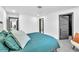 Bedroom with a serene blue bed, closet, and neutral walls creating a peaceful and inviting atmosphere at 3189 Montecito Dr, Las Vegas, NV 89120