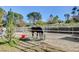 A horse is in a corral surrounded by mature trees on a sunny day at 3189 Montecito Dr, Las Vegas, NV 89120