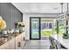 Elegant dining room with stylish decor, and sliding doors to pool area with lush landscaping at 3189 Montecito Dr, Las Vegas, NV 89120