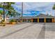 Stunning exterior with gray brick driveway, tropical landscaping, and glass panel garage doors at 3189 Montecito Dr, Las Vegas, NV 89120
