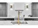 Modern kitchen features stainless steel appliances, a gold faucet, and grey and black cabinets at 3189 Montecito Dr, Las Vegas, NV 89120