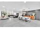 Spacious living room with a black leather couch, modern design, and dining room at 3189 Montecito Dr, Las Vegas, NV 89120
