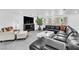 Spacious living room featuring a large leather sectional, statement fireplace and modern decor at 3189 Montecito Dr, Las Vegas, NV 89120