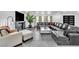Spacious living room featuring a large leather sectional, statement fireplace and modern decor at 3189 Montecito Dr, Las Vegas, NV 89120