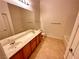 Bright bathroom features dual sinks, a bathtub, and tiled flooring at 3354 Indian Shadow St # 203, Las Vegas, NV 89129