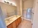 A well-lit bathroom with dual sinks, a large mirror, and a glass-enclosed shower at 3354 Indian Shadow St # 203, Las Vegas, NV 89129