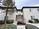 A building exterior featuring beige siding, well maintained landscaping and a stairway leading to the second floor at 3354 Indian Shadow St # 203, Las Vegas, NV 89129