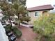 Exterior view of condo building, showcasing a well-maintained landscape and red tile roof at 3354 Indian Shadow St # 203, Las Vegas, NV 89129