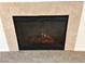 Close up of a cozy gas fireplace, featuring a screen, and tile surround at 3354 Indian Shadow St # 203, Las Vegas, NV 89129