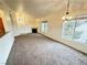 Spacious living room with a fireplace, plush carpet, and large windows for natural light at 3354 Indian Shadow St # 203, Las Vegas, NV 89129
